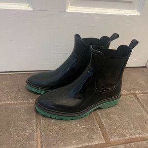Black rain boots with green bottoms. INC